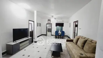 Spacious living room with modern furniture and dining area, perfect for family gatherings.