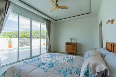 Spacious bedroom with pool view and modern decor in luxury home