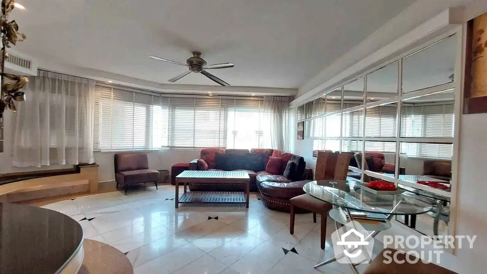 Spacious living room with modern furniture and large windows offering ample natural light.