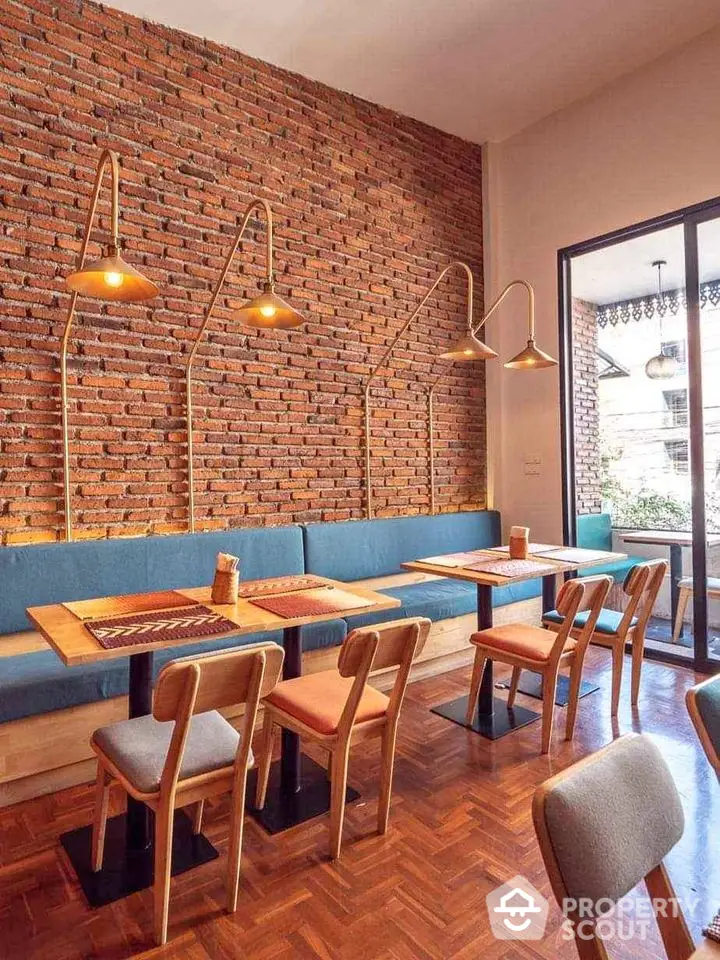 Charming cafe interior with brick wall and stylish lighting, perfect for cozy gatherings.