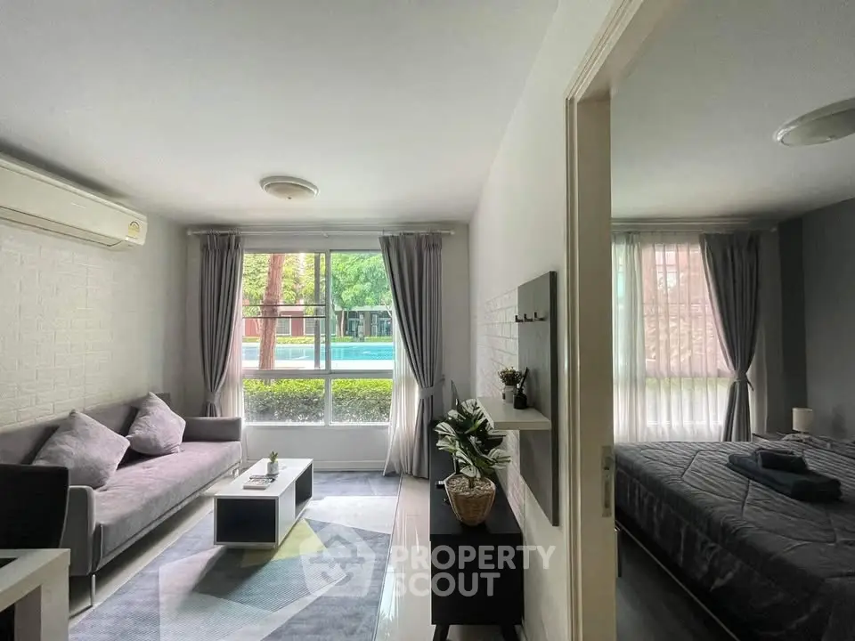 Modern living room and bedroom with large windows and stylish decor