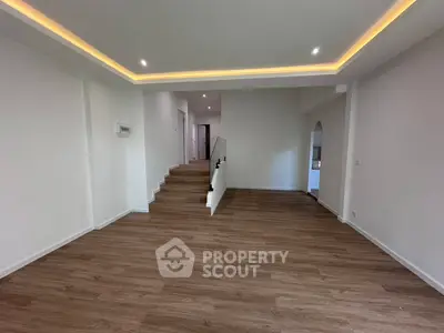 Spacious modern living room with elegant wooden flooring and recessed lighting