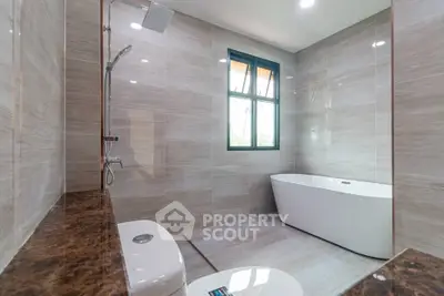 Luxurious modern bathroom with freestanding tub and elegant marble accents