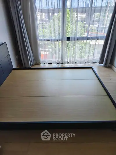 Modern bedroom with large window and minimalist design