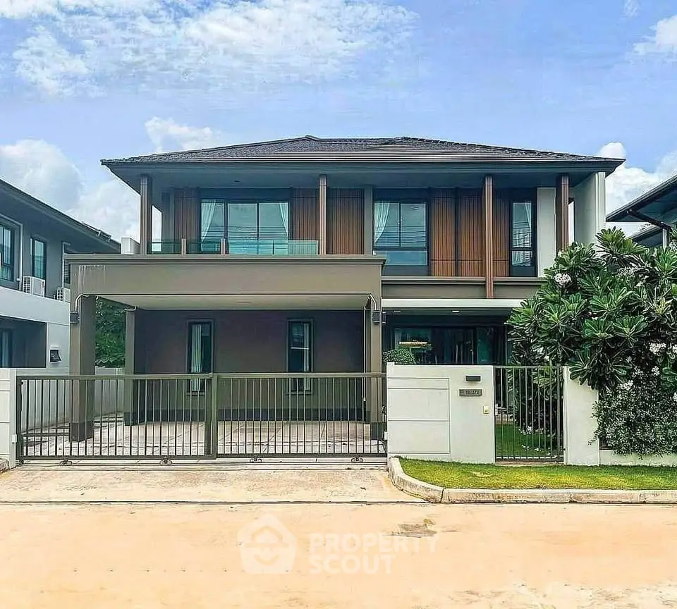 Modern two-story house with sleek design and spacious driveway in a serene neighborhood.