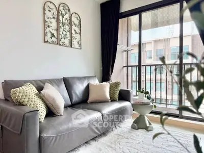 Stylish living room with modern sofa and balcony view in a contemporary apartment.