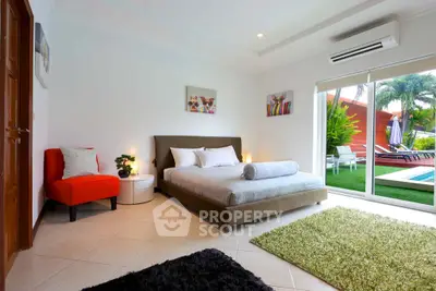 Luxurious bedroom with pool view and modern decor, perfect for relaxation and comfort.