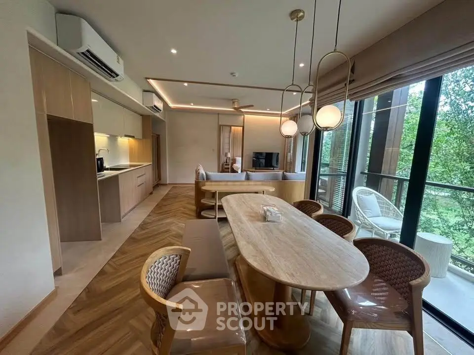 Luxurious open-plan living room with modern kitchen and scenic balcony view