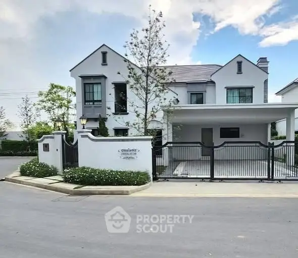 Elegant modern house with spacious driveway and lush greenery in a serene neighborhood.