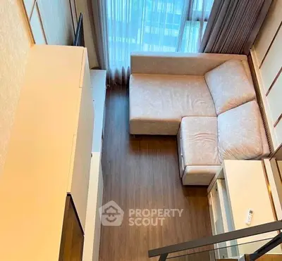 Modern living room with sleek design and large windows offering natural light.