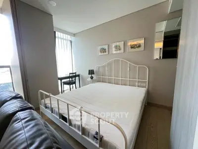 Modern bedroom with stylish decor and natural light, featuring a cozy bed and a work desk by the window.