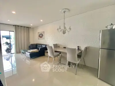Modern living room with elegant dining area and sleek refrigerator