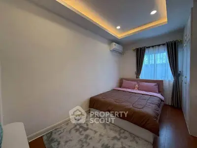 Cozy bedroom with modern lighting and plush bedding in a serene setting.