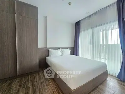 Modern bedroom with large window and wooden flooring, featuring a cozy bed and built-in wardrobe.