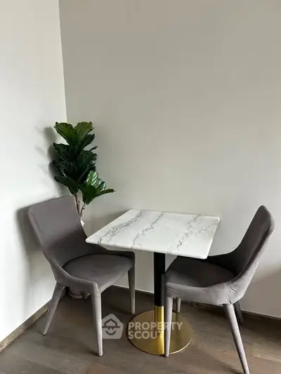 Cozy dining nook with marble table and plush chairs, perfect for intimate meals.