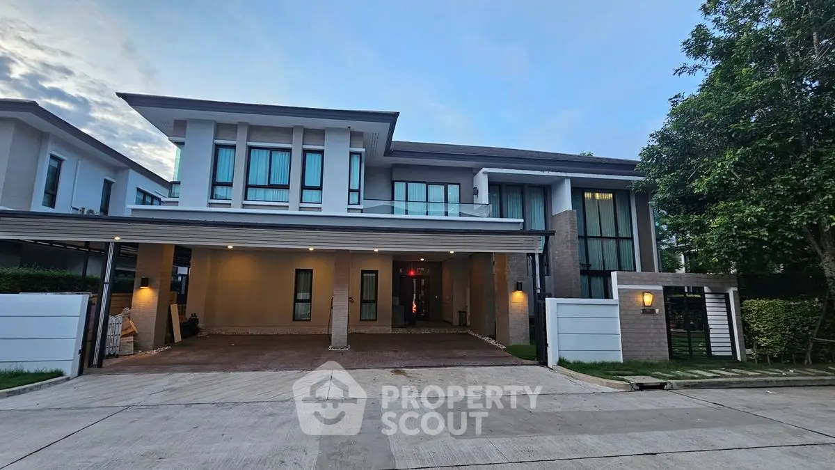 Modern two-story house with large windows and spacious driveway in a serene neighborhood.