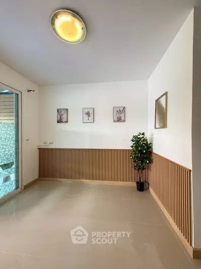 Spacious and bright interior with modern decor and elegant wall paneling, perfect for stylish living.