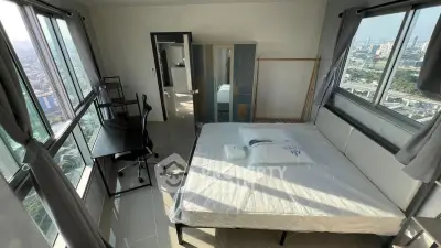 Spacious bedroom with panoramic city views and modern furnishings