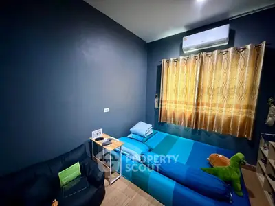Cozy bedroom with modern decor and air conditioning, featuring a comfortable bed and stylish curtains.