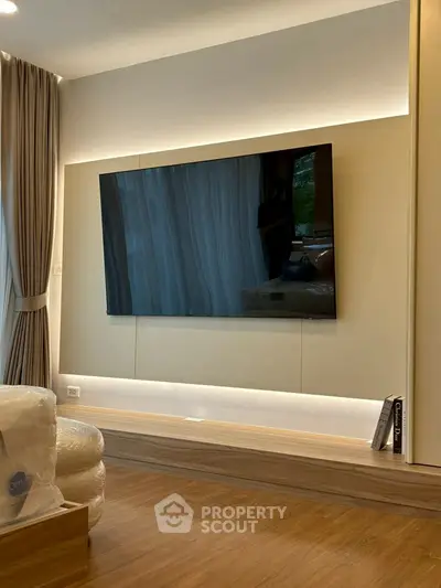 Modern living room with sleek TV and elegant wooden flooring