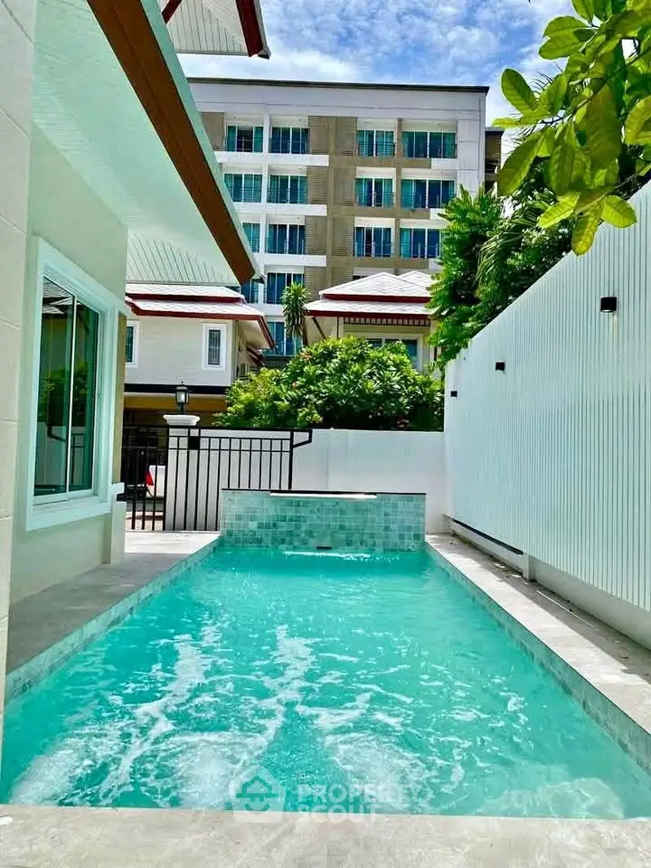 Luxurious private pool with modern architecture and lush greenery, perfect for relaxation and entertainment.