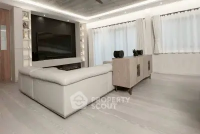 Spacious modern living room with sleek design and large TV