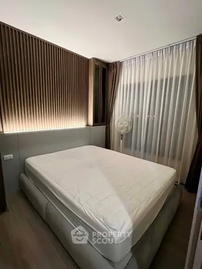 Modern bedroom with stylish wood paneling and large window