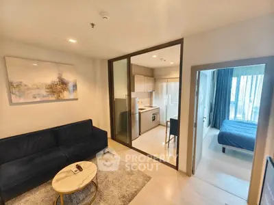 Modern apartment interior with cozy living room, compact kitchen, and bright bedroom.