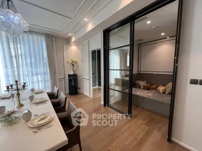Elegant dining room with modern decor and cozy seating area, featuring stylish lighting and wooden flooring.