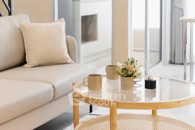 Elegant living room with cozy sofa and stylish coffee table in modern apartment.