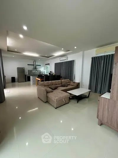 Spacious modern living room with open kitchen and stylish decor