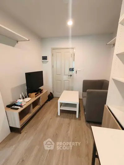 Cozy living room with modern furniture and wooden flooring, perfect for relaxation and entertainment.