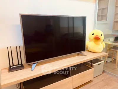 Modern living room with sleek TV setup and playful decor