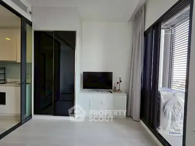 Modern living room with sleek design and large windows offering natural light.