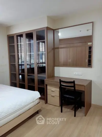 Spacious bedroom with elegant wooden furniture and ample storage space
