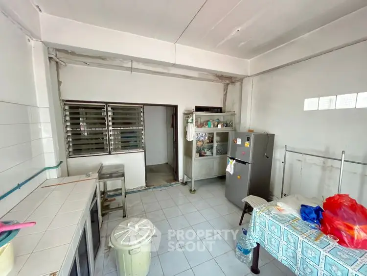 Spacious kitchen with tiled flooring and ample storage space