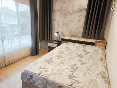 Cozy bedroom with large window and modern decor