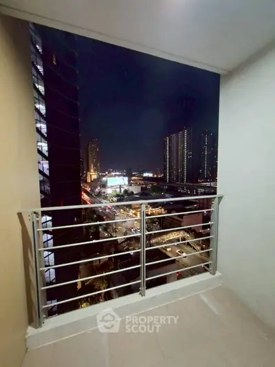 Spacious balcony with stunning city night view, perfect for relaxation and entertainment.