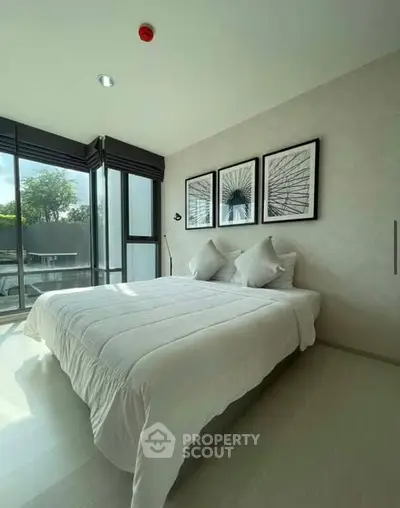 Bright and modern bedroom with large windows and stylish decor in a contemporary home.