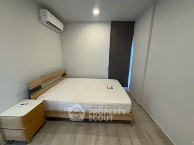 Modern minimalist bedroom with wooden furniture and air conditioning