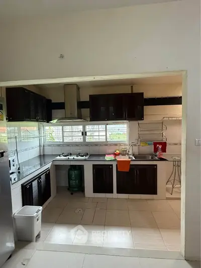 Spacious kitchen with modern appliances and open layout, perfect for culinary enthusiasts.