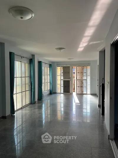 Spacious living room with large windows and natural light