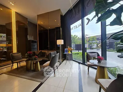 Luxurious modern lobby with elegant seating and floor-to-ceiling windows offering garden views.
