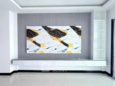Modern living room with elegant marble accent wall and built-in shelving