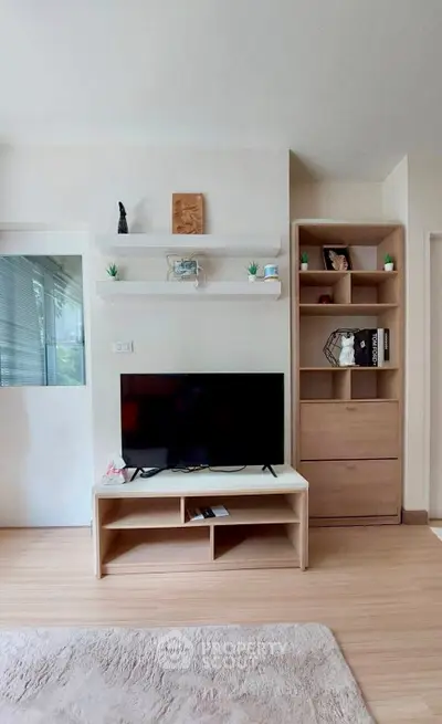 Modern living room with sleek TV stand and stylish shelving, perfect for contemporary living.