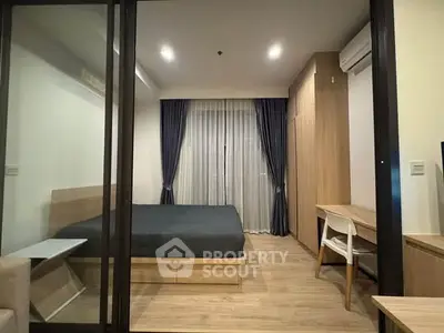 Modern bedroom with wooden flooring, large bed, and stylish curtains in a cozy apartment.