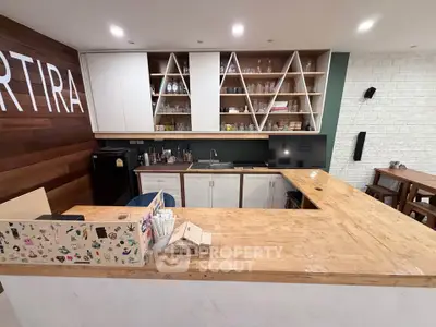 Modern kitchen with open shelving and wooden countertops in a stylish apartment.