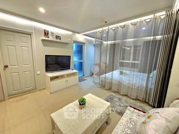 Modern studio apartment with open layout and stylish decor, featuring a cozy living area and bedroom.