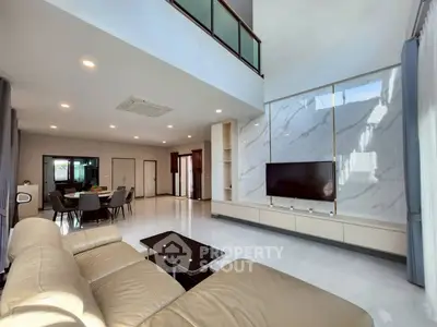 Spacious modern living room with high ceiling and elegant marble wall