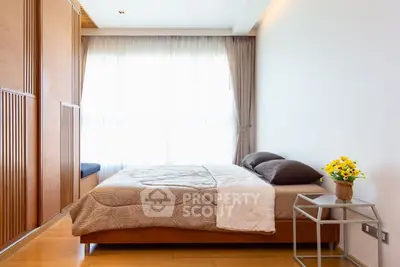 Modern bedroom with wooden accents and large window for natural light